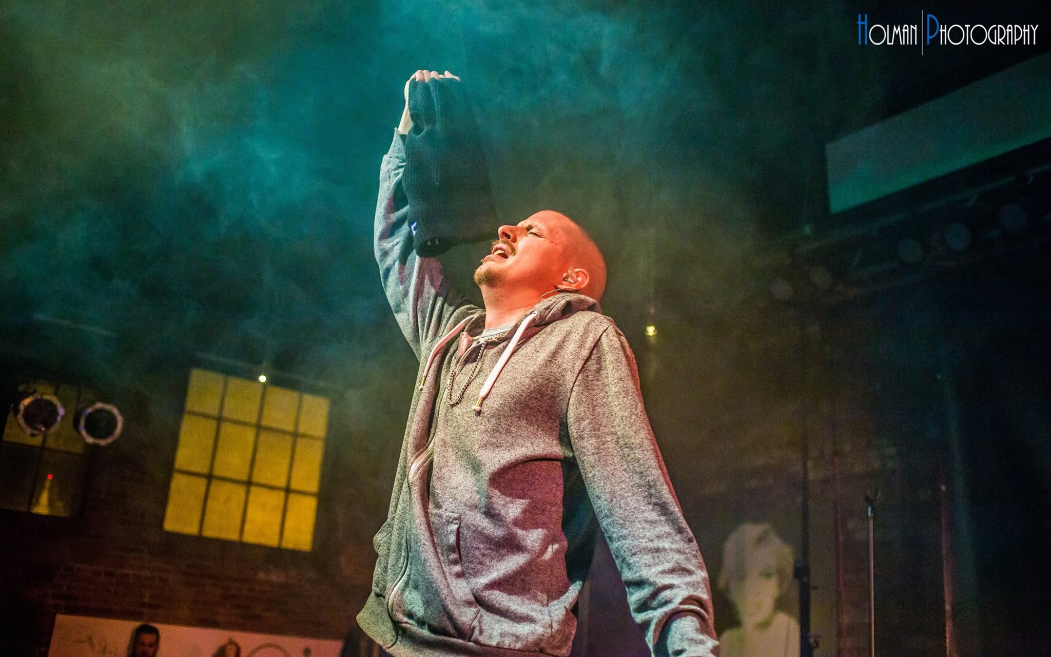 Prof performing at ICON Lounge, arm raised, October 2015